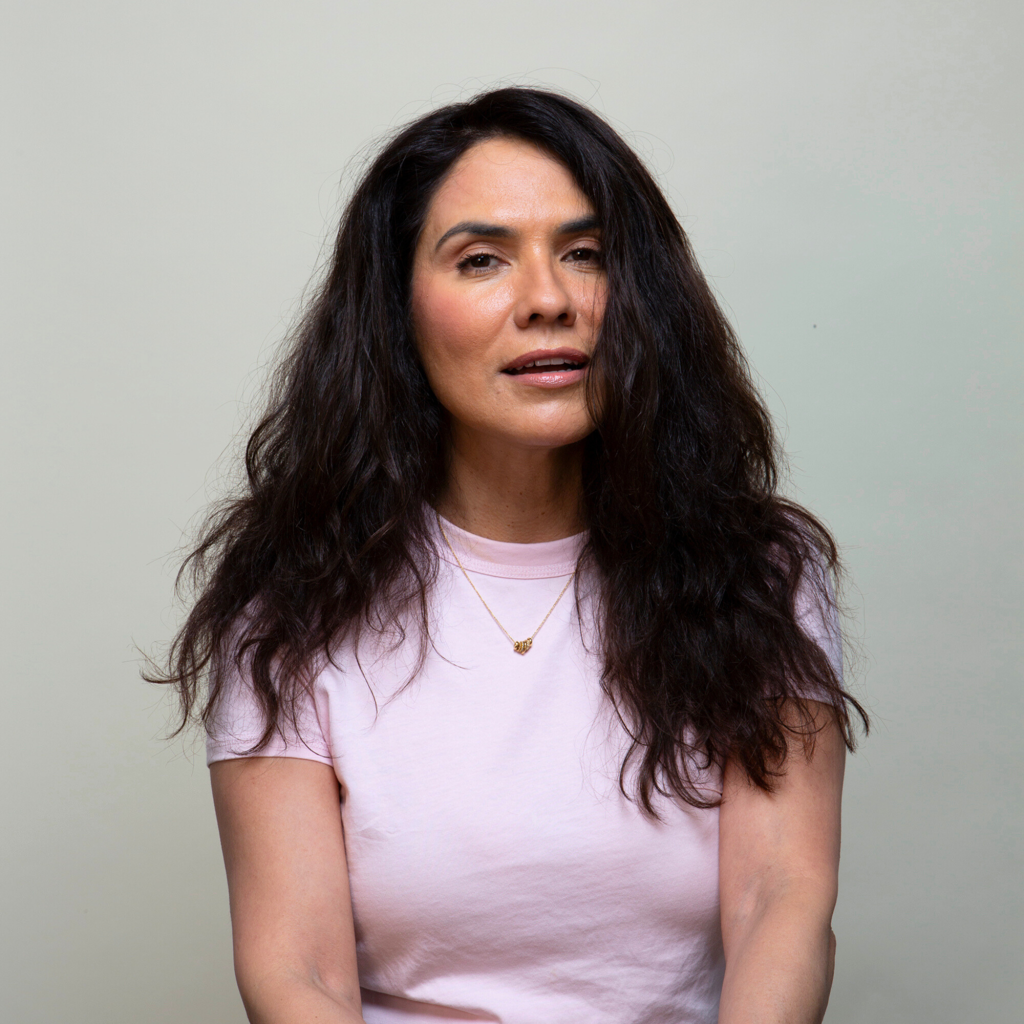 Woman wearing a Remy human hair topper, showcasing a natural and stylish look.