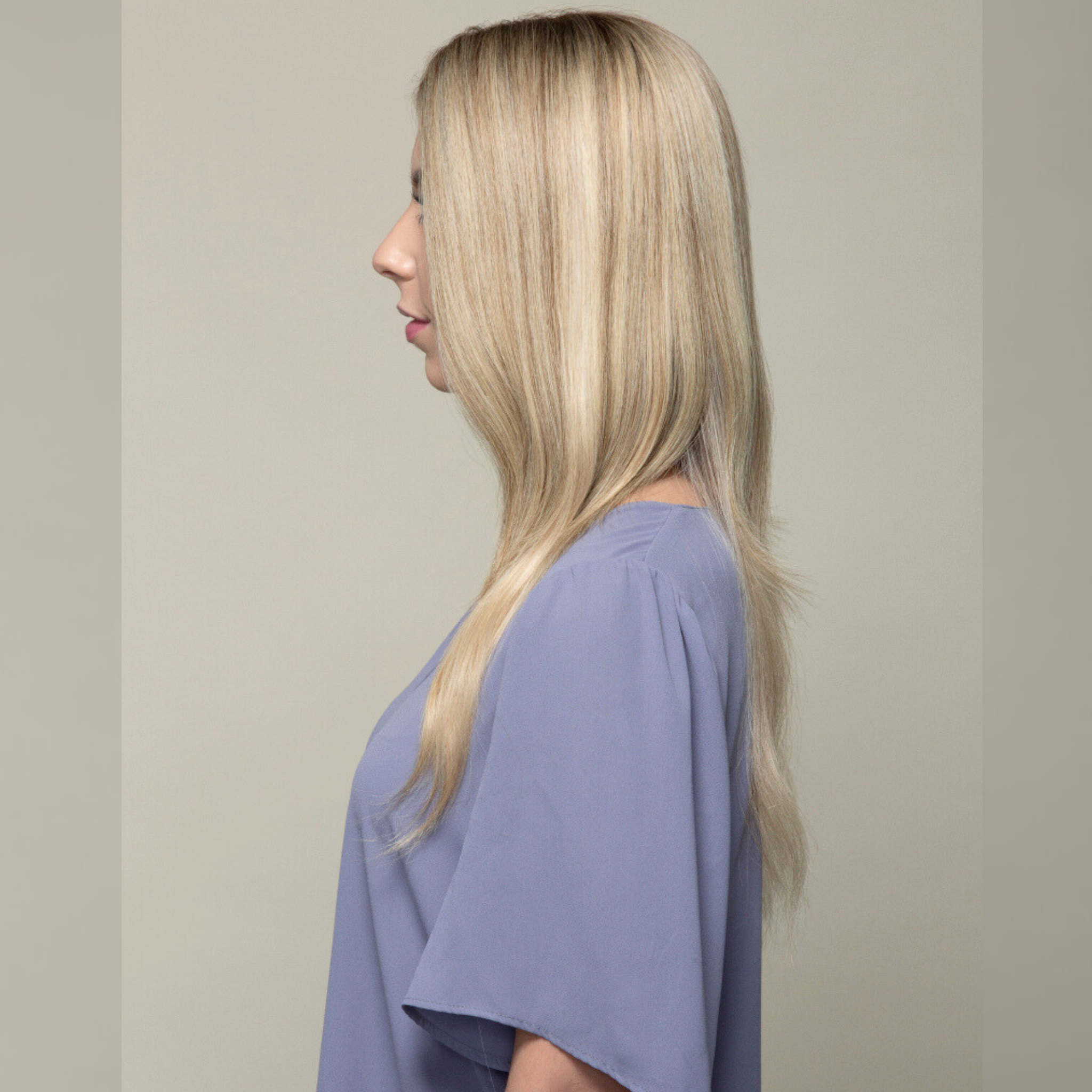 Side view image of a woman with a wearing a Remy human hair topper featuring.