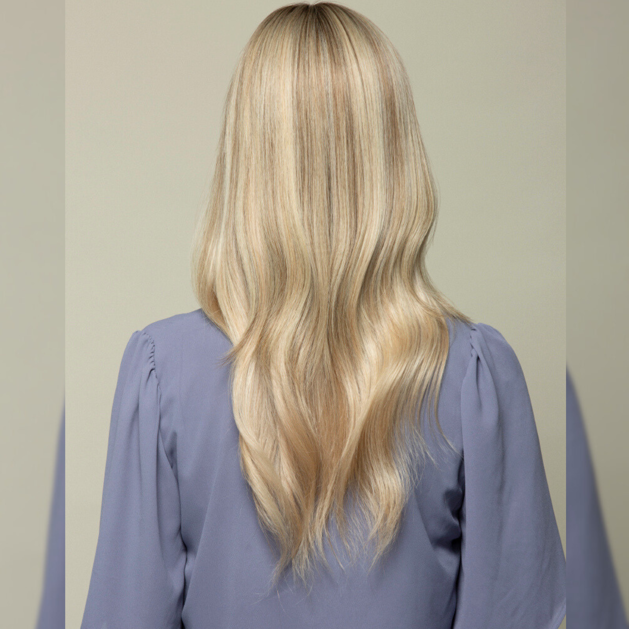 Back view image of a woman with a wearing a Remy human hair topper featuring.