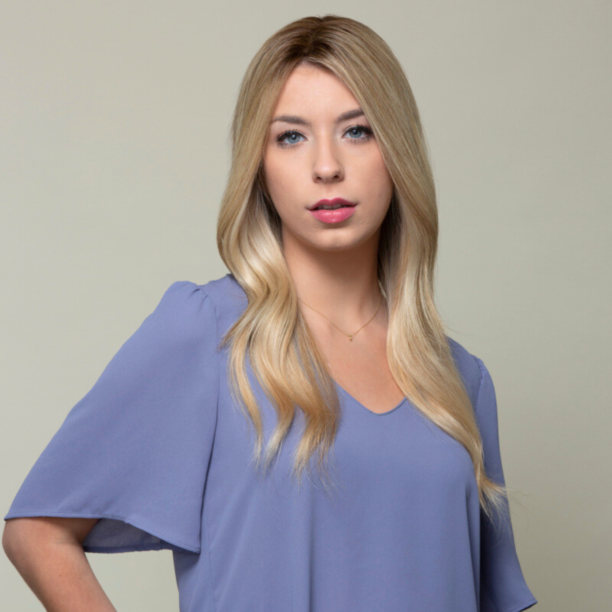 Woman with a subtle, stylish look wearing a Remy human hair topper featuring a mono top for a seamless blend.