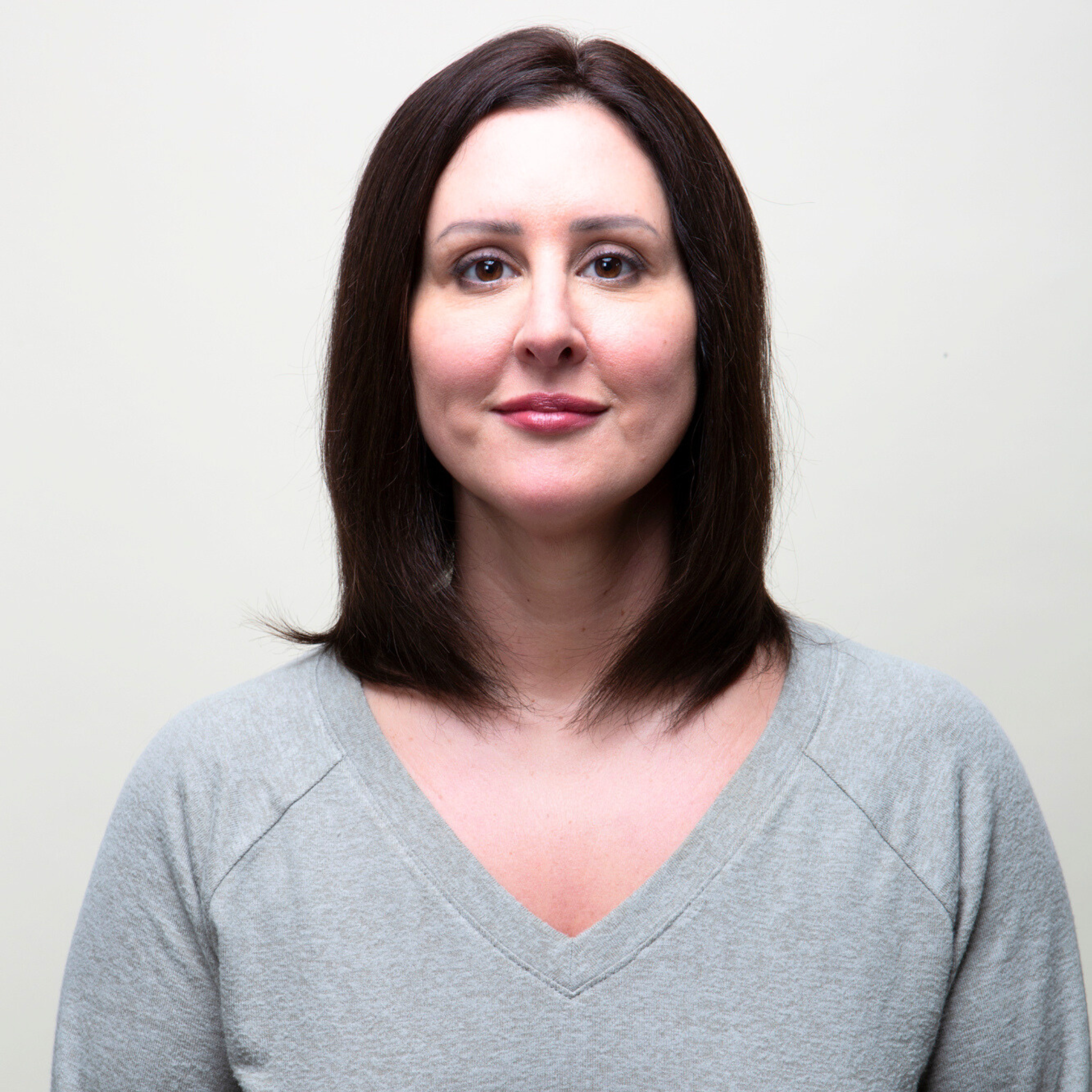 A woman models a mono top Remy human hair topper, highlighting its realistic appearance and elegant style.